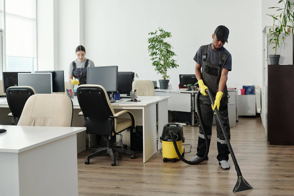 young-african-american-man-workwear-cleaning-floor-contemporary-office